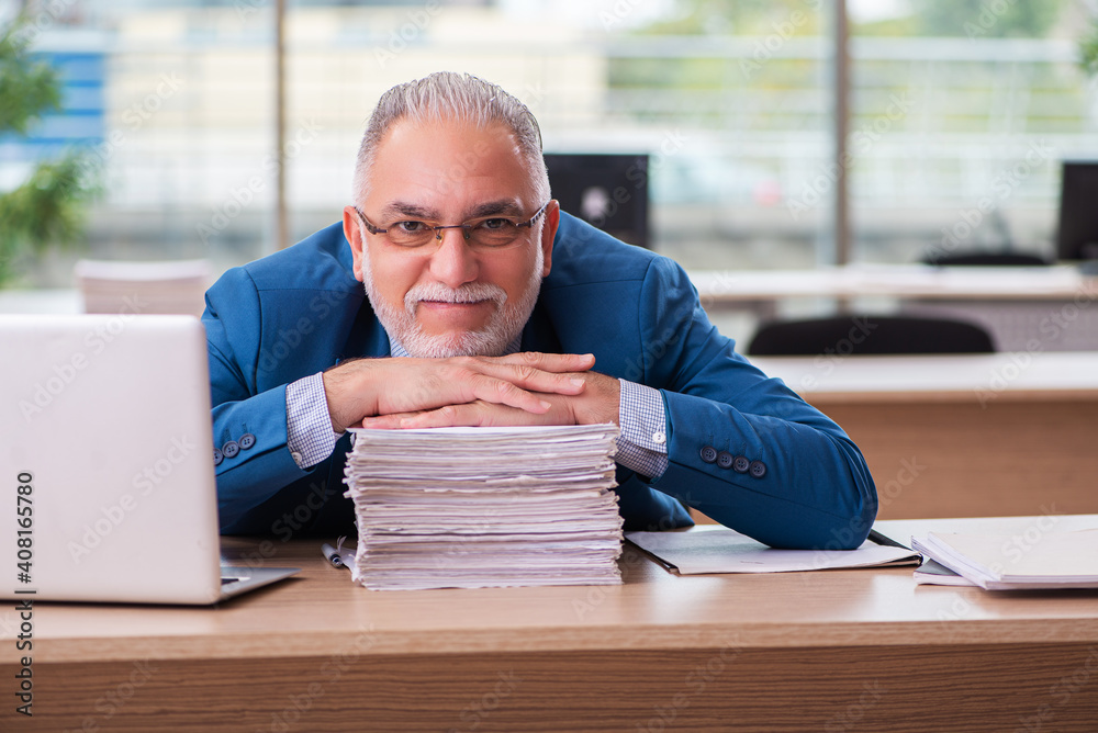 Old male boss employee working in the office Old male boss employee working in the office