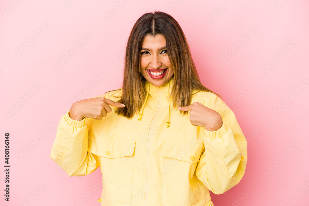 Young indian woman isolated on pink background surprised pointing with finger, smiling broadly. Young indian woman isolated on pink background surprised pointing with finger, smiling broadly.