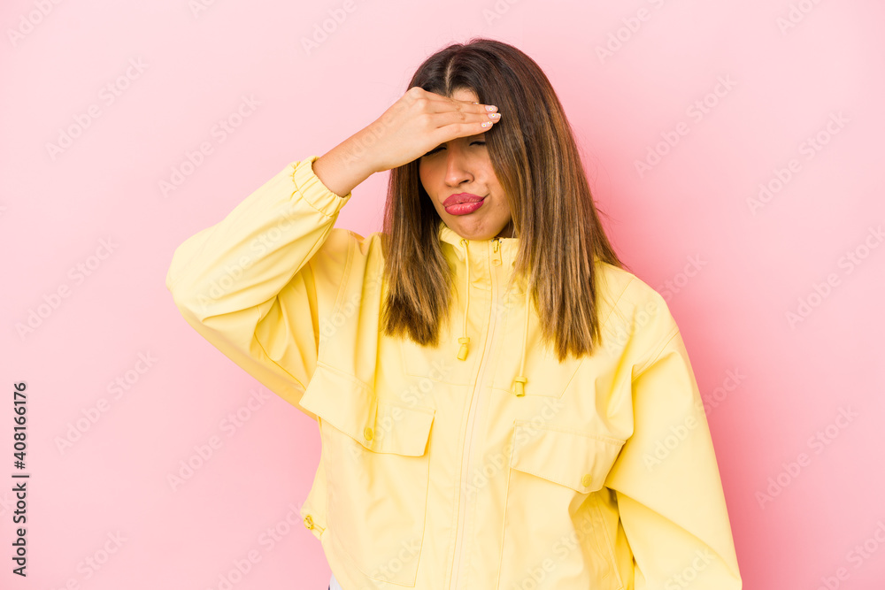 Young indian woman isolated on pink background having a head ache, touching front of the face. Young indian woman isolated on pink background having a head ache, touching front of the face.