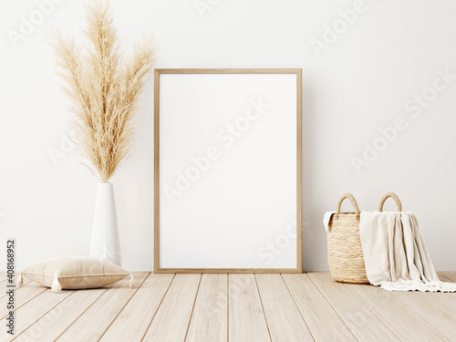 Vertical frame mockup standing on wooden floor in living room interior with dried pampas grass, woven basket, blanket and pillow with tassels on white wall background. 3d rendering, 3d illustration photo