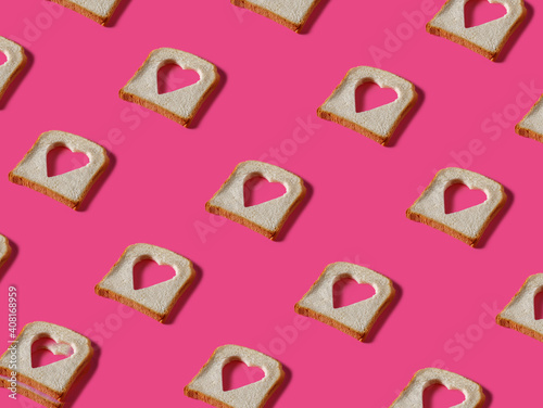 Принти на полотні Toasted bread slices with cut in shape of heart on pink background