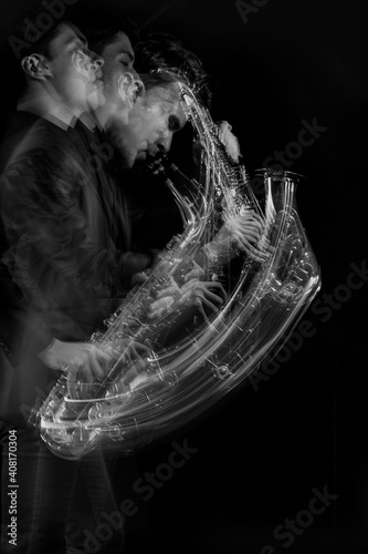 A stroboscopic image of a male saxophone player in motion against a black background