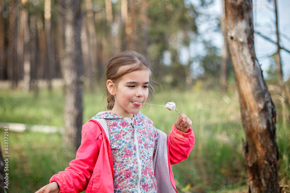 New normal escape step, wild nature walking and family outdoor recreation. Kids cooking and tasting marshmallows fried on fire, hike at weekend, lifestyle New normal escape step, wild nature walking and family outdoor recreation. Kids cooking and tasting marshmallows fried on fire, hike at weekend, lifestyle