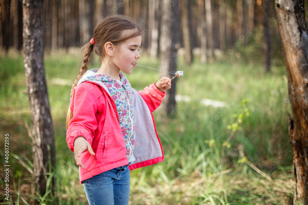 New normal escape step, wild nature walking and family outdoor recreation. Kids cooking and tasting marshmallows fried on fire, hike at weekend, lifestyle New normal escape step, wild nature walking and family outdoor recreation. Kids cooking and tasting marshmallows fried on fire, hike at weekend, lifestyle