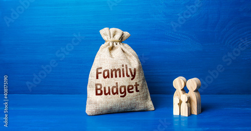 Family figurines and family budget money bag. Security, purchasing power. Financial literacy. Financial support for social institutions. Well-being of the population. Basic income. Cost studies.