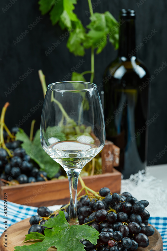 A glass of white wine with fruits aside