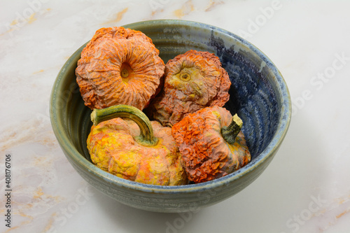 Bilde på lerret Rotten left over dehydrated pumpkins  in ceramic bowl on table