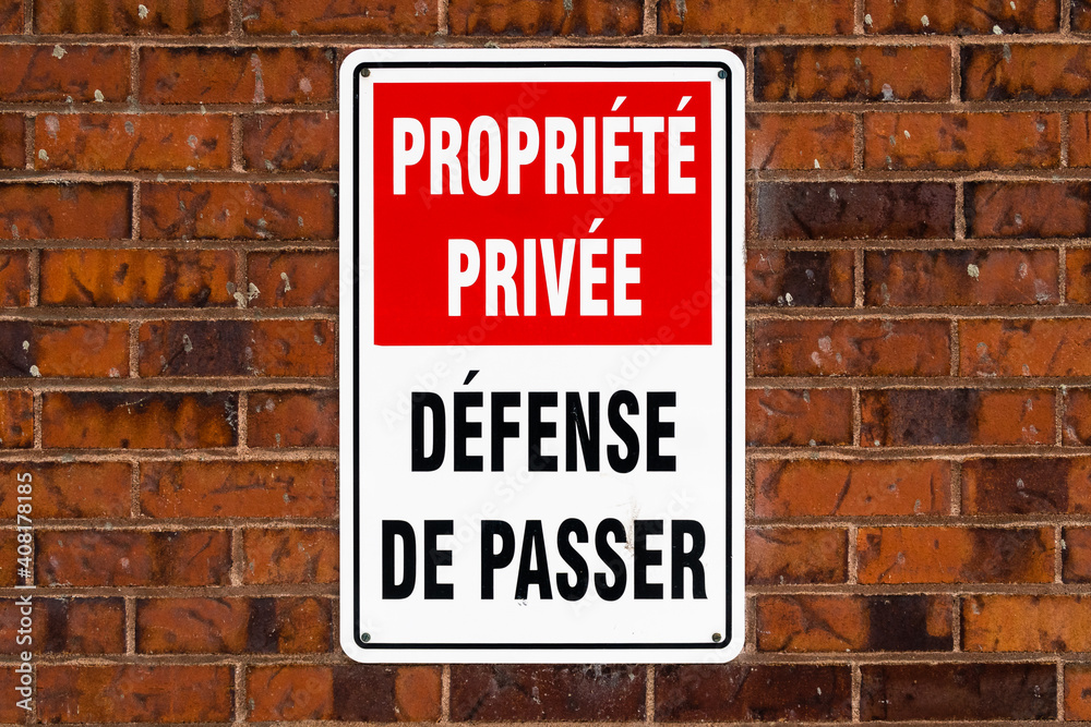 Warning sign on a brick wall (Translation : Warning sign on a brick wall (Translation :