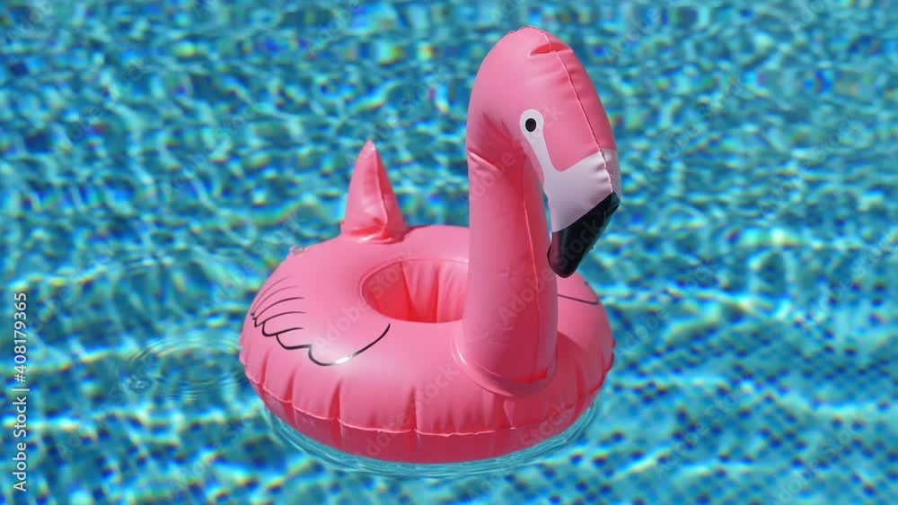 Inflatable toy of pink flamingo near swimming pool at poolside, nobody