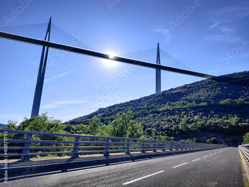 A summer panorama of a great white cable bridge. Bridge crossing the valley.  Natural panoramic view. Highest bridge. Bridge over the river