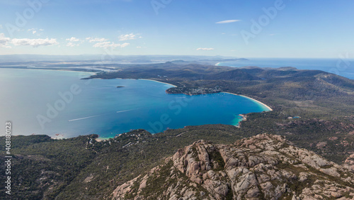 Beautiful high angle panoramic aerial drone view of Coles Bay and Freycinet National park with Richardsons Beach and Coles Bay Village. The famous Hazards mountain range in the foreground.