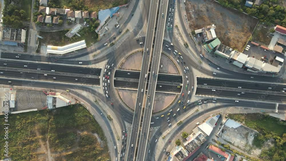 Aerial drone top-down angle shot of roundabout and crossing expressway with evening busy traffic. Aerial drone top-down angle shot of roundabout and crossing expressway with evening busy traffic.