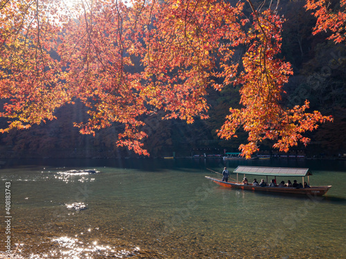 Beautiful fall color and Katsura River with boat