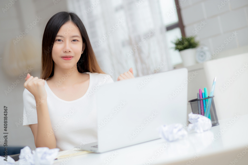 Young asian woman confident working at home with laptop computer and thinking idea for planning, freelance happy girl expression with excited and success using notebook thought, business concept. Young asian woman confident working at home with laptop computer and thinking idea for planning, freelance happy girl expression with excited and success using notebook thought, business concept.