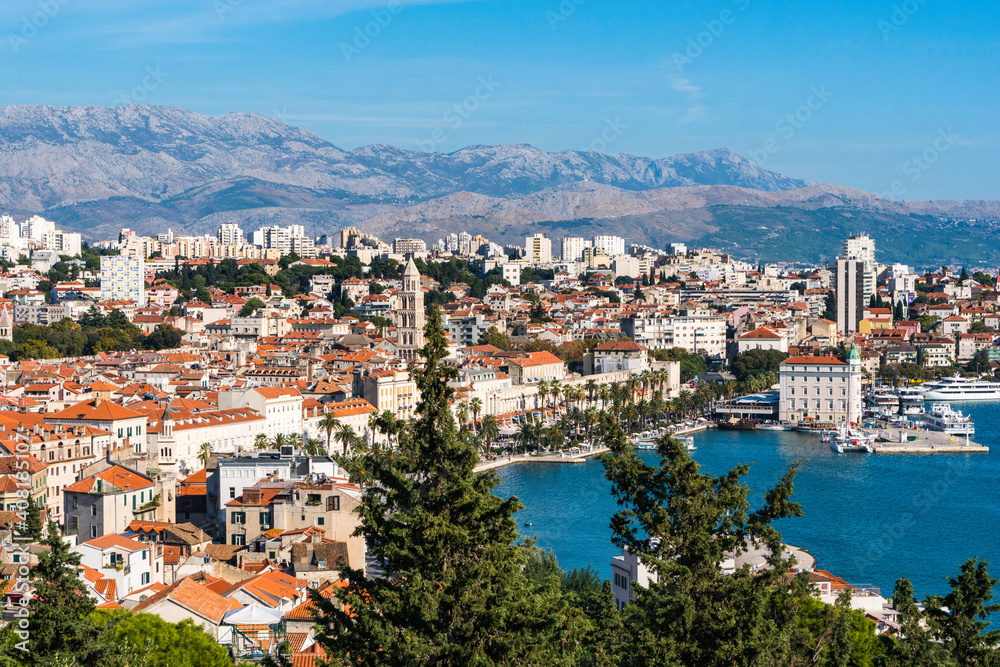 The harbour, red roofs and mountains of Split, Croatia as seen from the cafe on Marjan Hill.