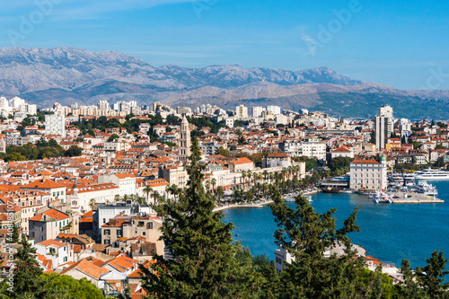 The harbour, red roofs and mountains of Split, Croatia as seen from the cafe on Marjan Hill. © Sandy