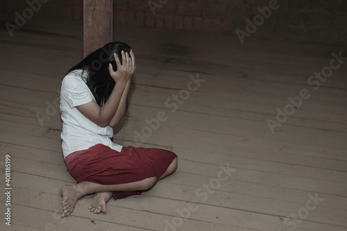 Human trafficking concept.Sad Young girl sit alone feeling bad in old room.women victims of trafficking.