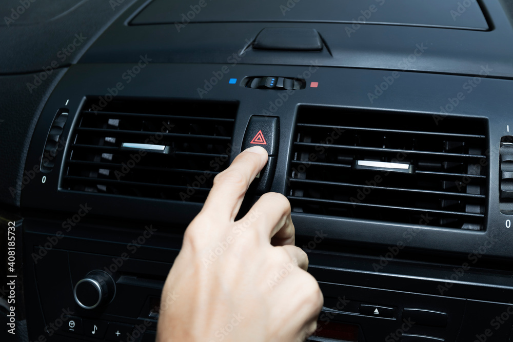 Close up hand press the emergency light in the car, Fingers press button.for open the contract emergency light in car. Emergency button press for open emergency light warning sign symbol out side car Close up hand press the emergency light in the car, Fingers press button.for open the contract emergency light in car. Emergency button press for open emergency light warning sign symbol out side car