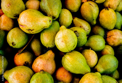 Group of many green healthy guavas next each other forming a texture
