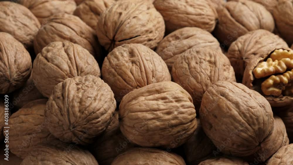 Whole Walnut closeup. Rotating nuts background, nobody Whole Walnut closeup. Rotating nuts background, nobody
