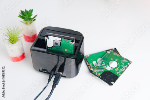 Canvas Print Hdd and ssd hard drives in docking station with on the white table