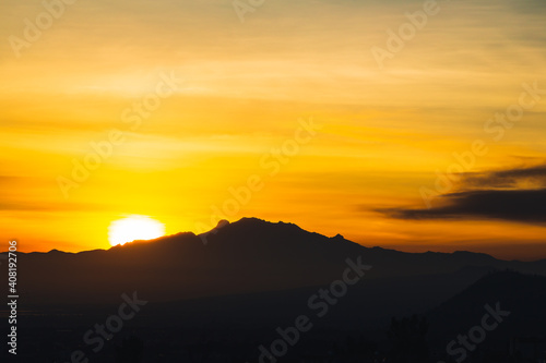 Sunrise over the volcanoes in a cloudy day