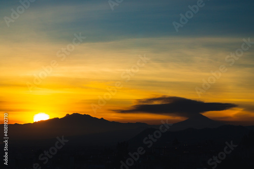 Sunrise over the volcanoes in a cloudy day
