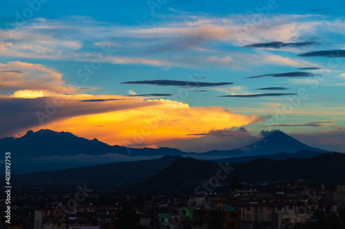 Sunrise over the volcanoes in a cloudy day