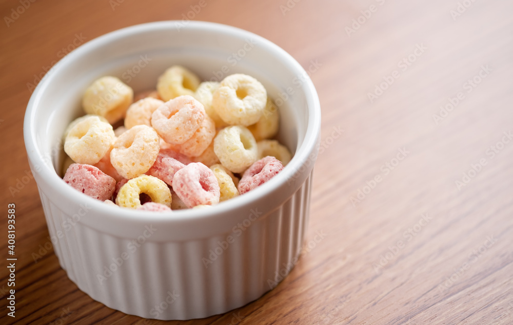 Cereal flakes in bowl ceramic with copy space,Breakfast concept.Food with delicious fruity taste and fruity colours.It's made with maize,wheat,and barley. Cereal flakes in bowl ceramic with copy space,Breakfast concept.Food with delicious fruity taste and fruity colours.It's made with maize,wheat,and barley.