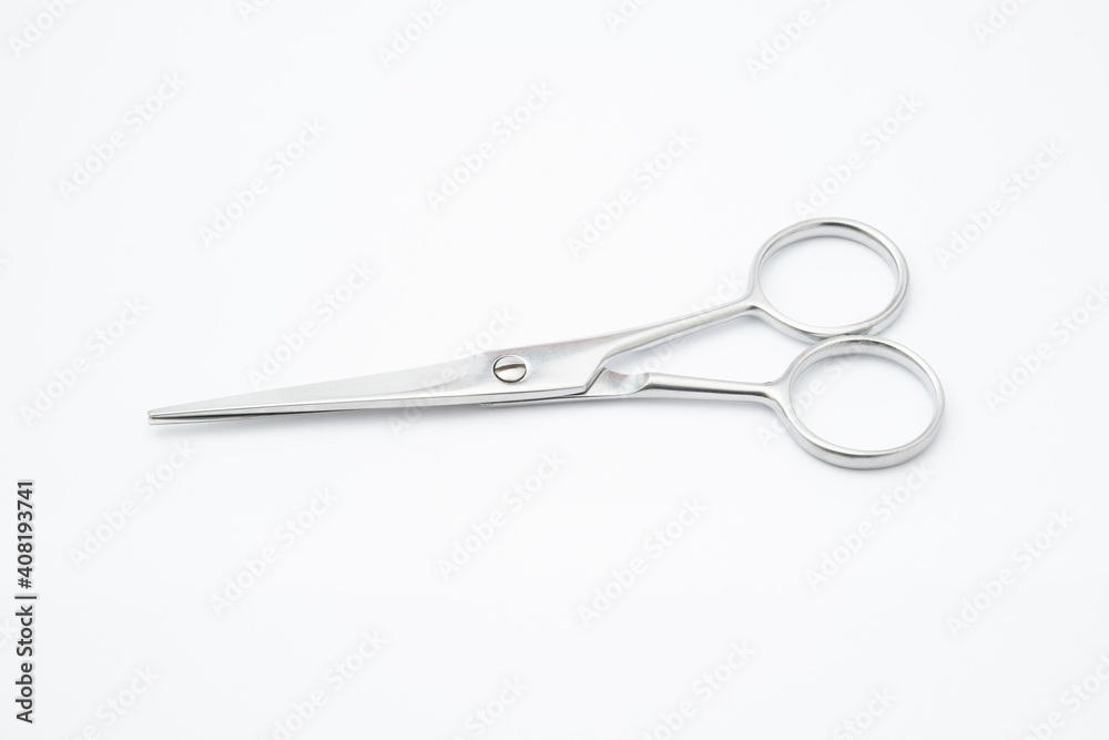 Silver scissors on white background.Paper cutting tool.Items for cutting hair on white background. Silver scissors on white background.Paper cutting tool.Items for cutting hair on white background.