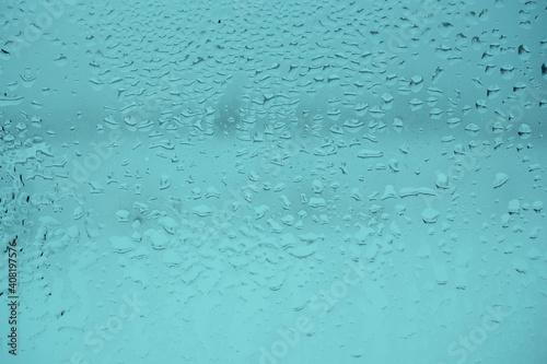 Wet glass texture. Abstract toned green background. Macro.