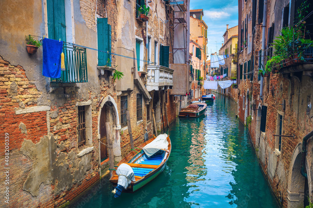 Waterfront houses in narrow water canal, Venice, Italy
