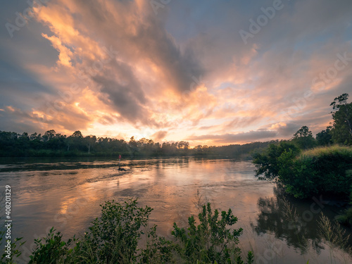 Dramatic Riverside Sunrise with Cloud Reflections