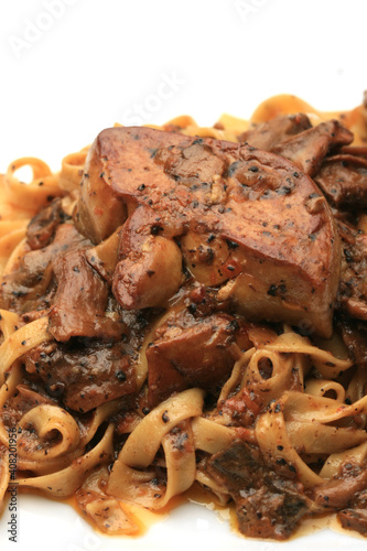 Grilled Foie gras steak with with Fettuccine pasta on restaurant table