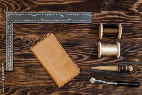 handmade leather wallet with tools from the workshop. genuine leather accessory