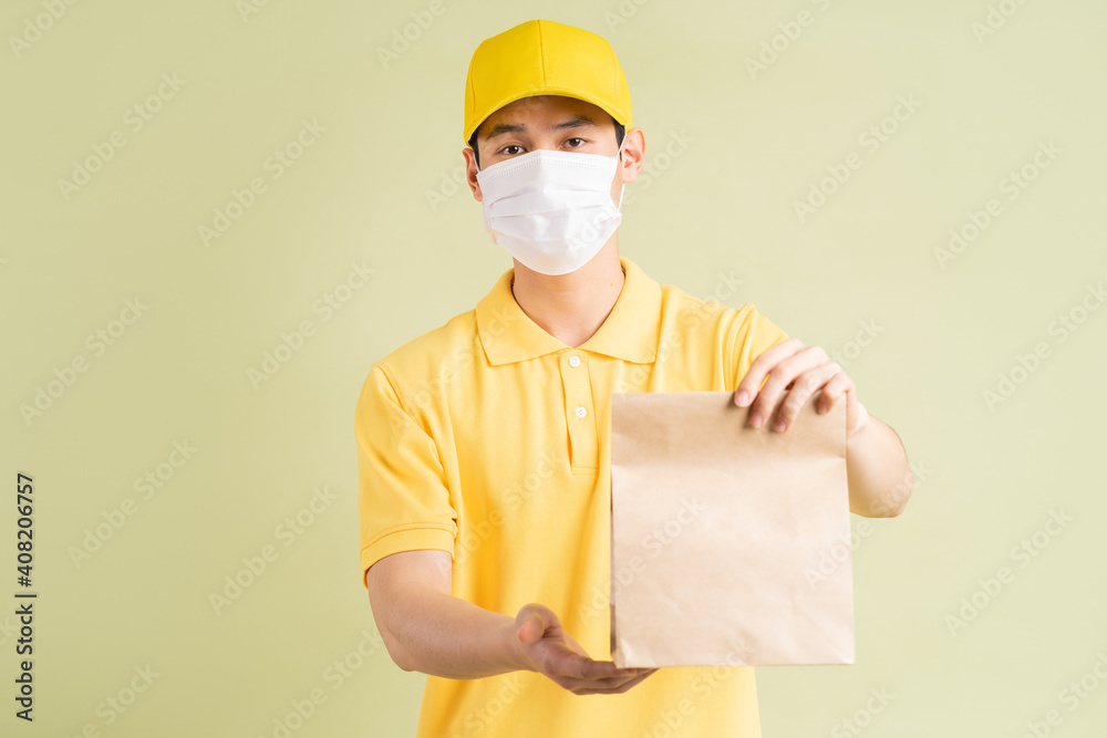 The masked Asian delivery man was holding the paper bag