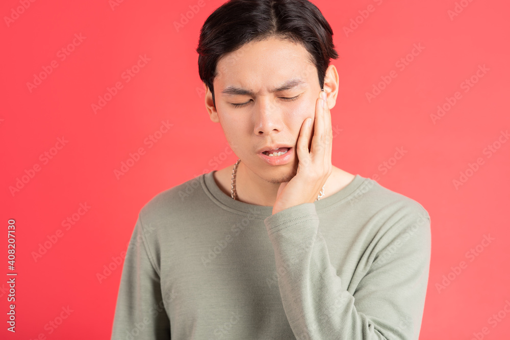 A photo of a handsome Asian man suffering from tooth decay A photo of a handsome Asian man suffering from tooth decay