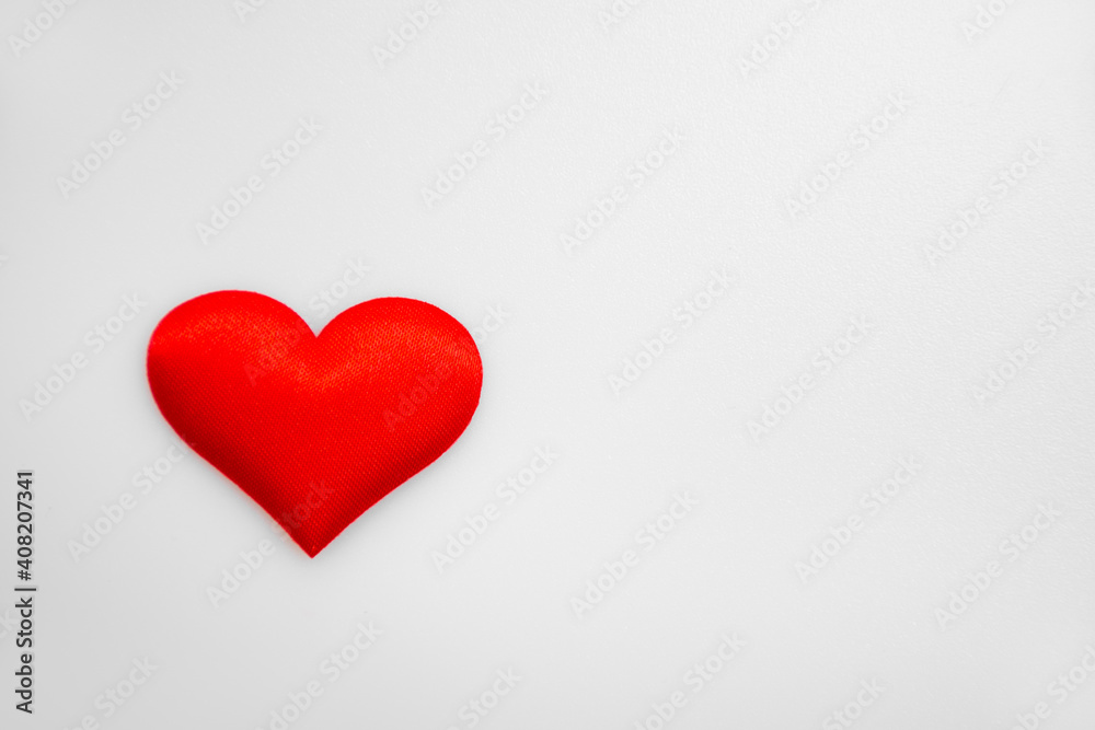 One single textured red heart on top of each other on a white or gray background: place for text, St. Valentine's Day background, minimalism One single textured red heart on top of each other on a white or gray background: place for text, St. Valentine's Day background, minimalism