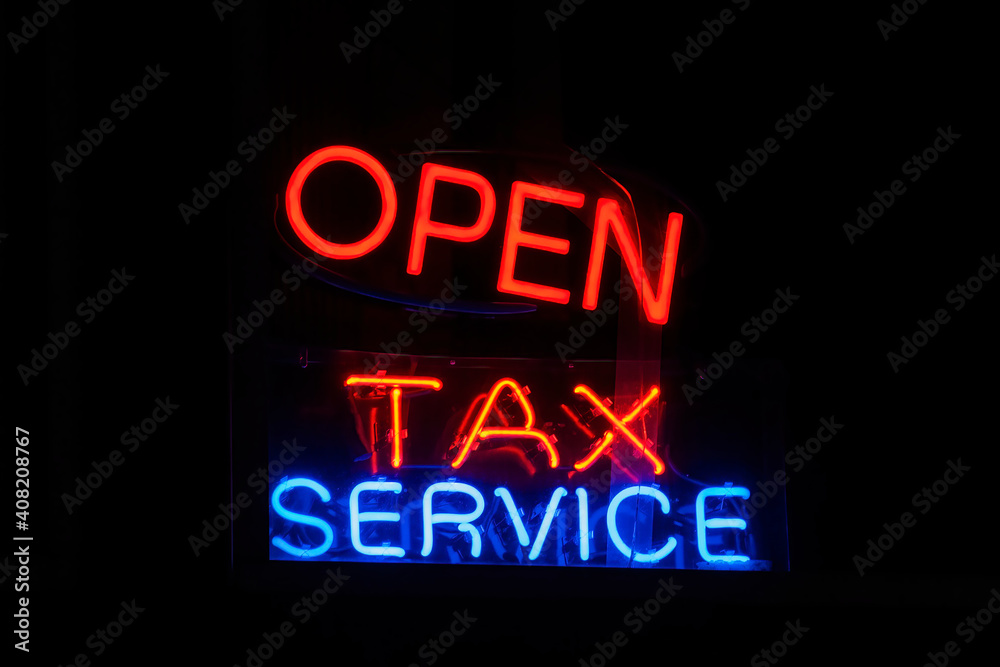 'TAX SERVICE' neon sign on black background 