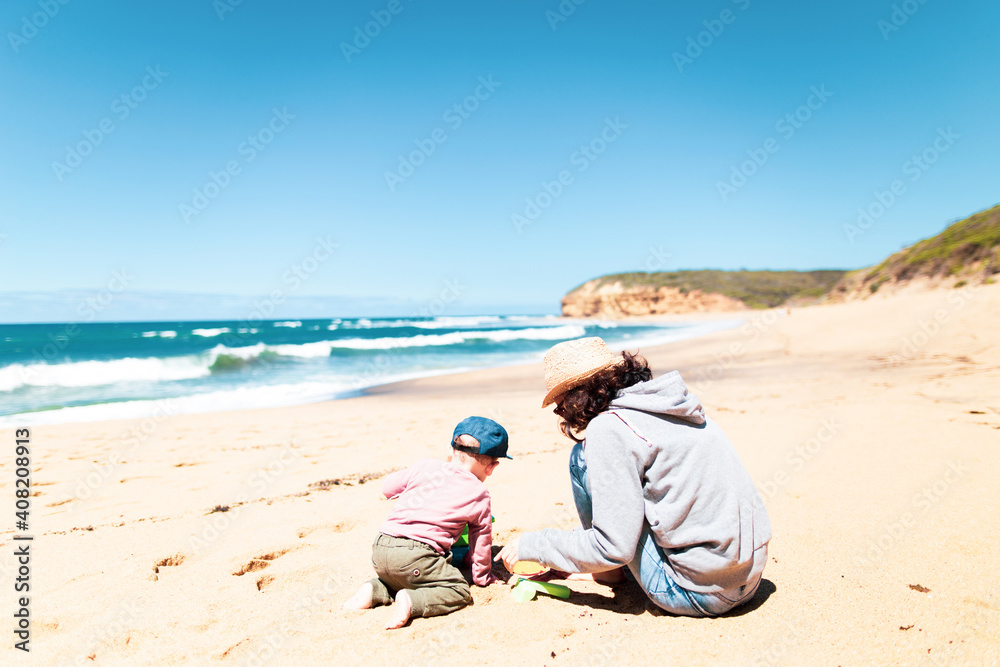 Baby playing on the beach with his mother Baby playing on the beach with his mother