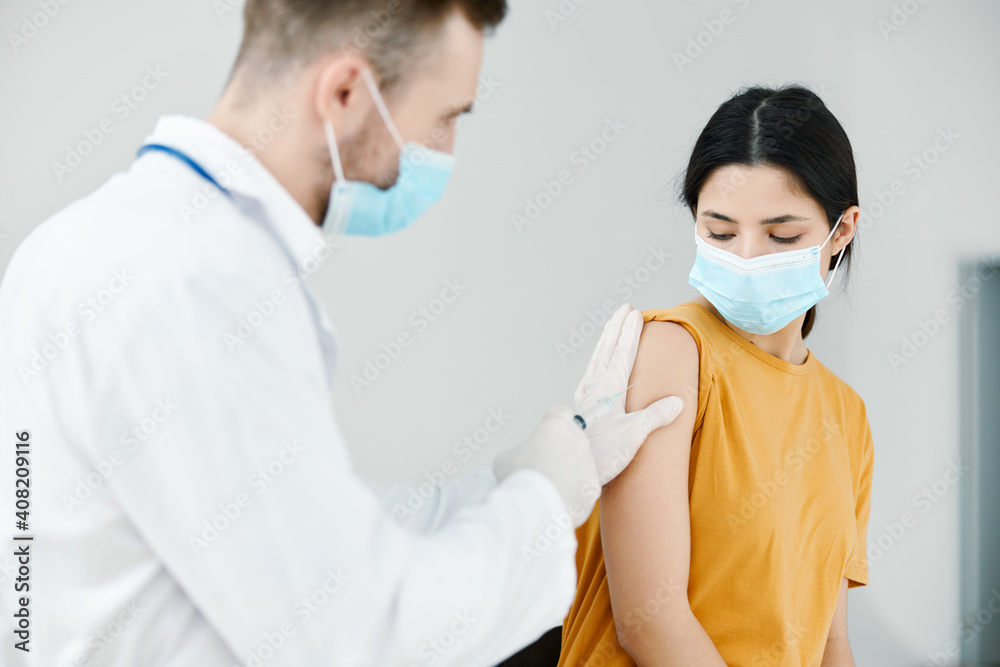 caring doctor injects covid-19 vaccine into female patient's shoulder vaccination caring doctor injects covid-19 vaccine into female patient's shoulder vaccination
