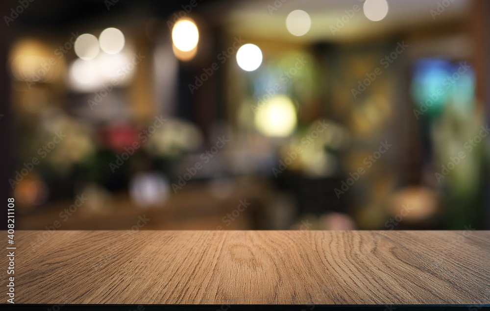 Empty wooden table in front of abstract blurred background of coffee shop . can be used for display or montage your products.Mock up for display of product Empty wooden table in front of abstract blurred background of coffee shop . can be used for display or montage your products.Mock up for display of product