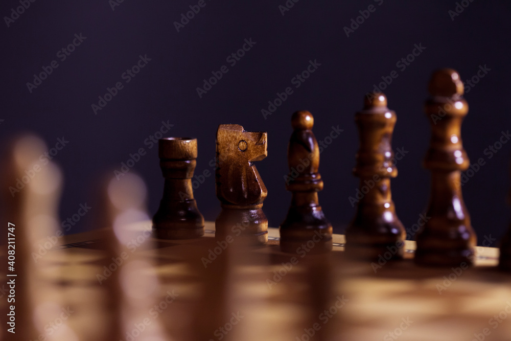 Wooden chess in a contrasting light. A game of chess, an intellectual competition, Wooden chess in a contrasting light. A game of chess, an intellectual competition,