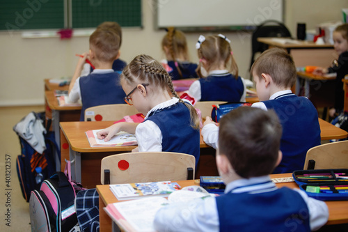Pupils at desks in class on lesson