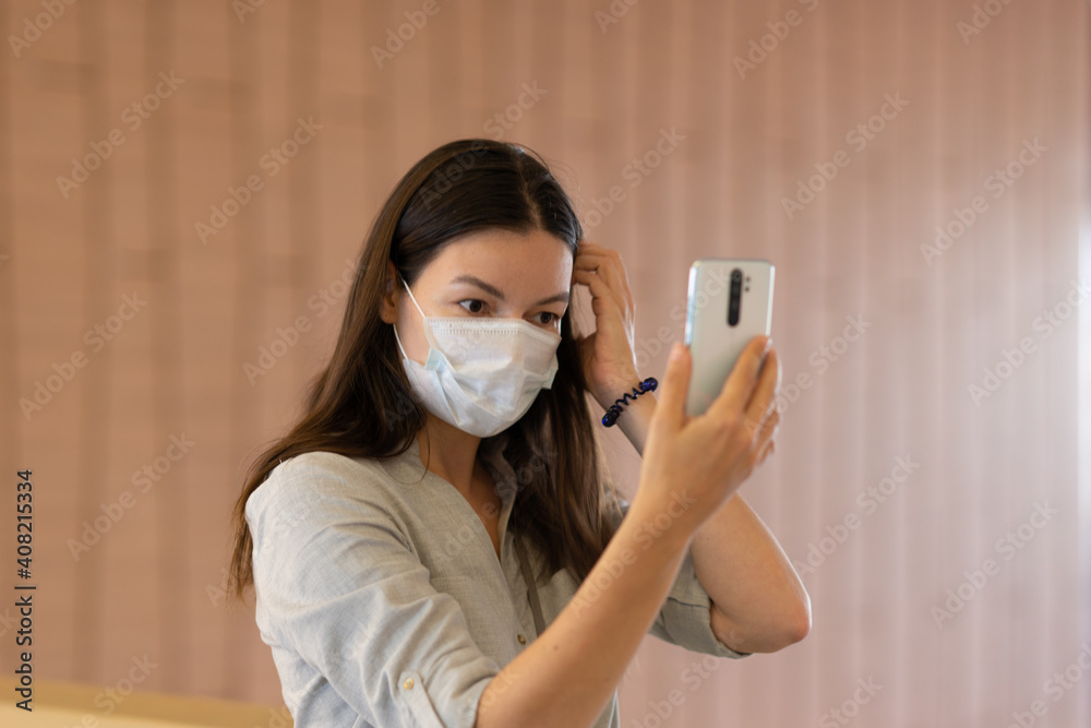 young woman in a medical mask on her face, respiratory protection during the coronavirus pandemic.