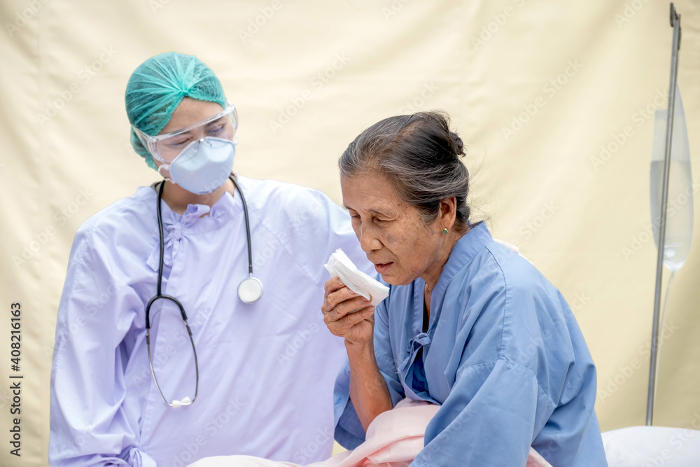 Elderly woman, The doctor examines the symptoms of cough of the patient at the field hospital, They both wore masks due to the covid 19 epidemic, health medical checkup concept Elderly woman, The doctor examines the symptoms of cough of the patient at the field hospital, They both wore masks due to the covid 19 epidemic, health medical checkup concept
