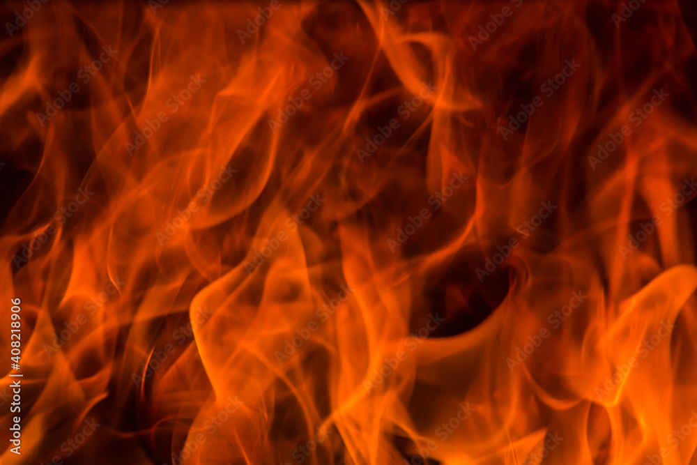 Orange flames on a dark background. Orange flames on a dark background.