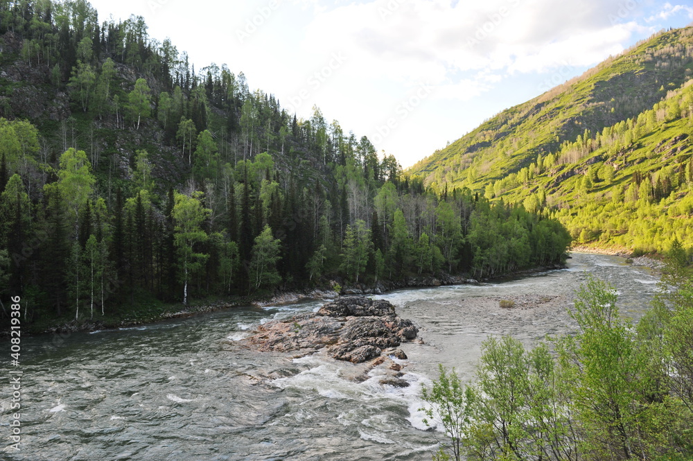 Ridder, Kazakhstan - 06.05.2013 : The Irtysh River, which flows along a mountainous and hilly area with different vegetation. Ridder, Kazakhstan - 06.05.2013 : The Irtysh River, which flows along a mountainous and hilly area with different vegetation.