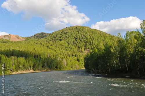 Ridder, Kazakhstan - 06.05.2013 : The Irtysh River, which flows along a mountainous and hilly area with different vegetation. photo