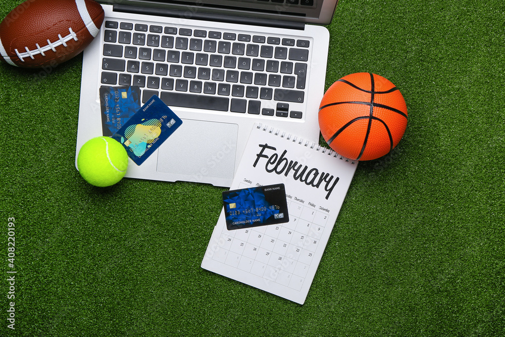 Obraz premium Laptop, credit cards and balls on color background. Concept of sports bet